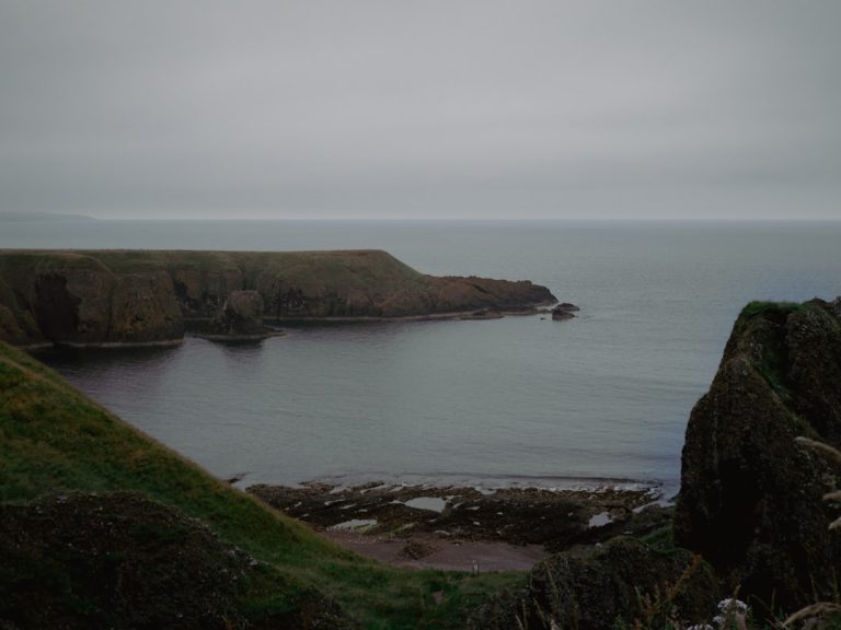 Dramatic volcanic landscape of the Isle of Skye with rugged cliffs meeting the sea under moody Scottish skies