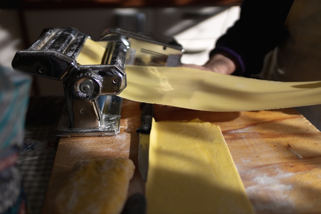 Fresh handmade tortellini being folded on a flour-dusted board in Bologna Italy
