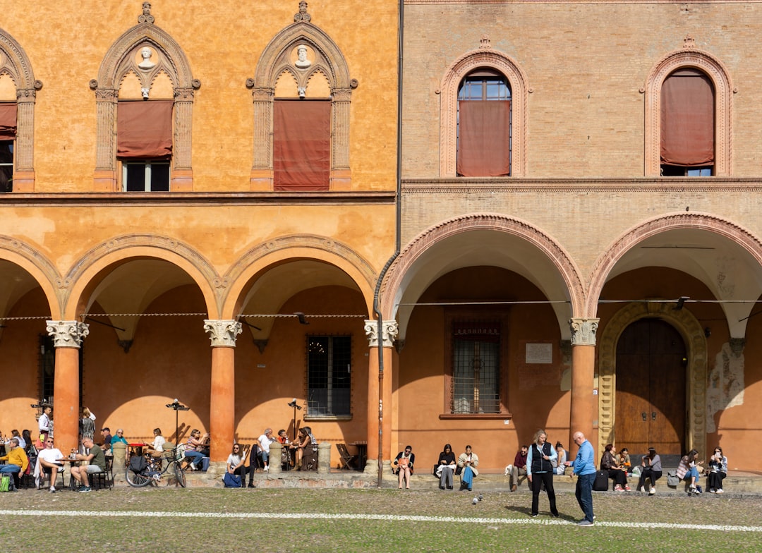 Morning light filtering through Bologna's medieval porticoes near Piazza Maggiore