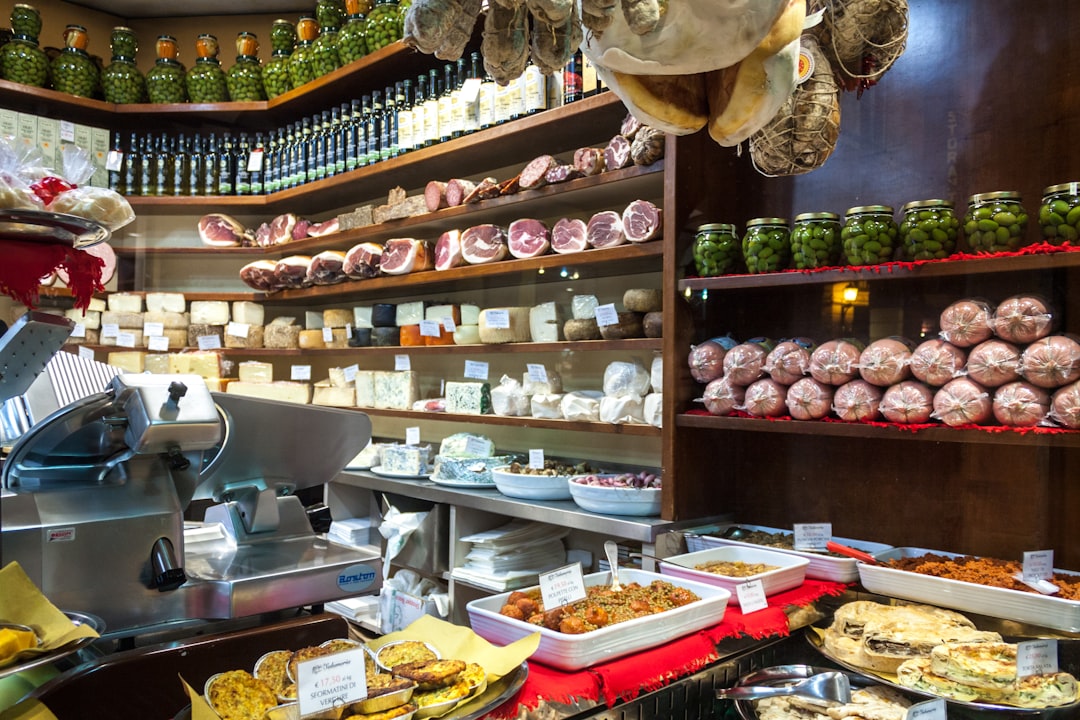 Bologna Quadrilatero market stalls with cured meats and Parmigiano Reggiano cheese