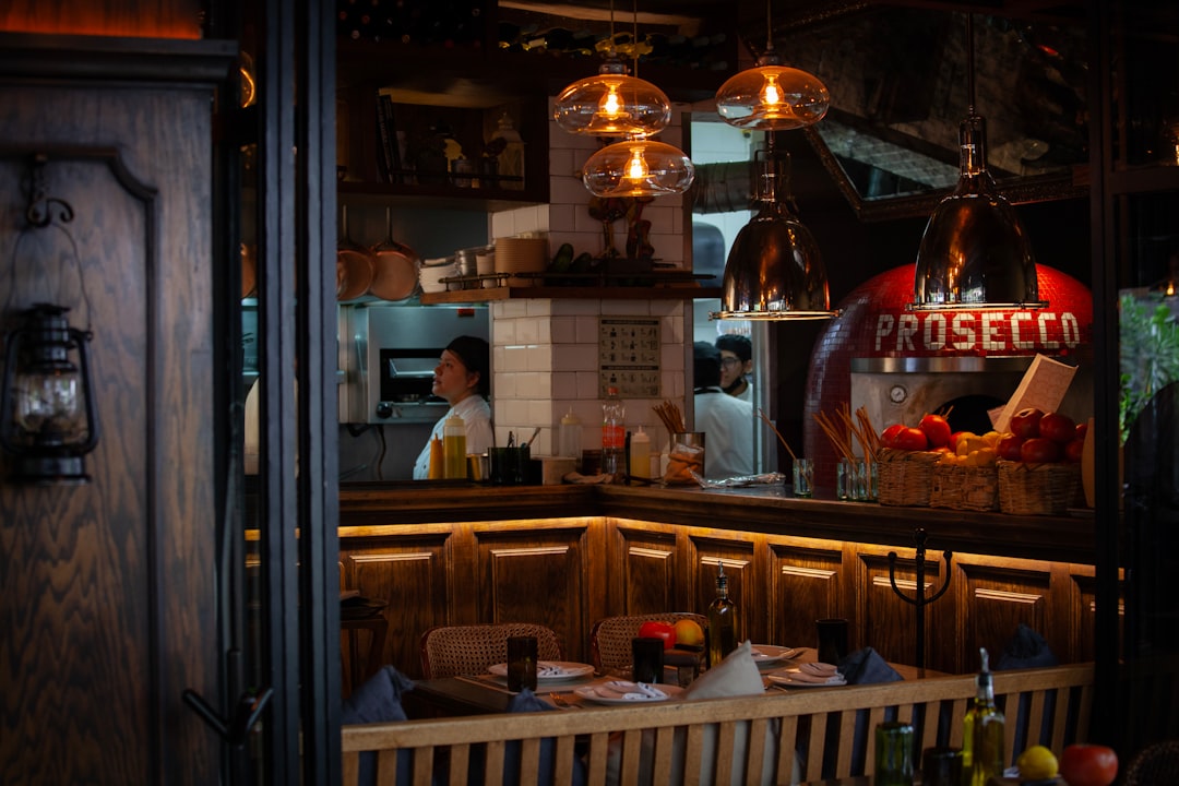 Interior of a traditional trattoria in Bologna with fresh pasta plates and warm lighting