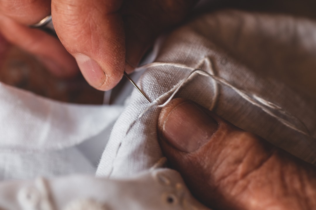 Bobbin lacemaker hands at work at the Kantcentrum Lace Centre in Bruges Belgium