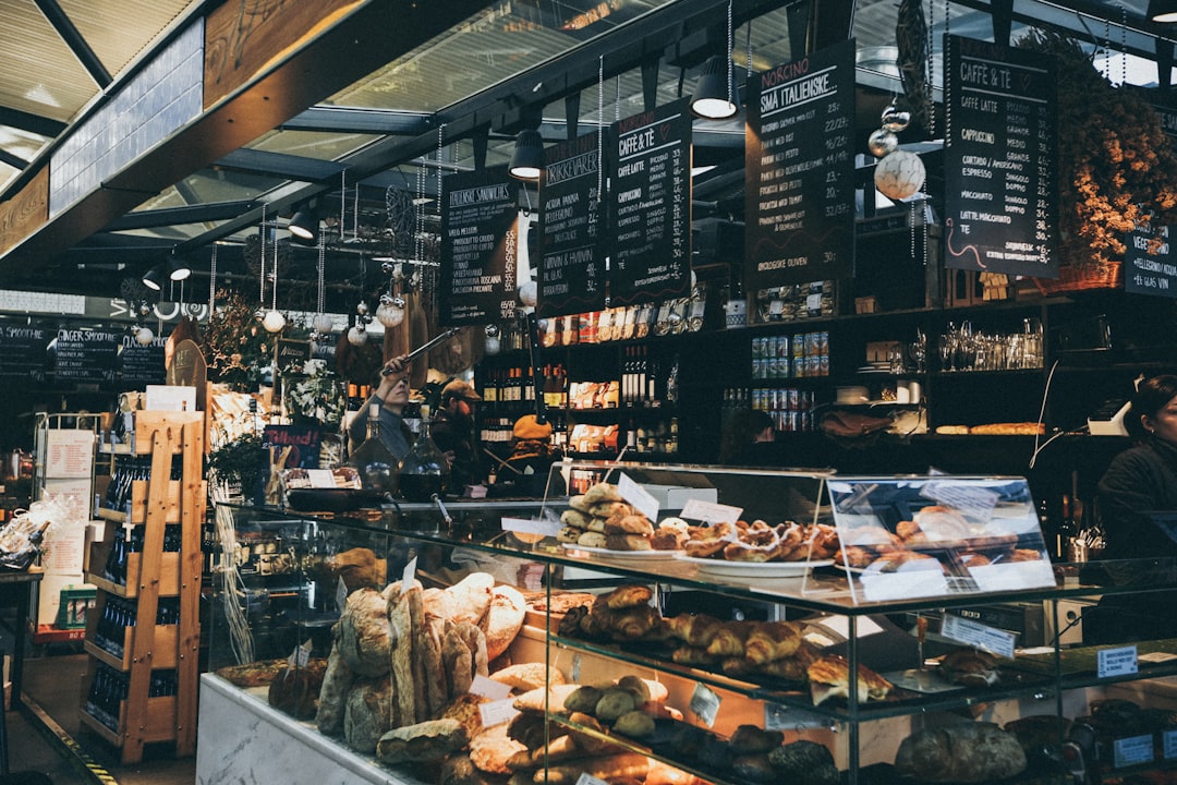 Copenhagen bakery display case with Danish cardamom buns and pastries in warm morning light