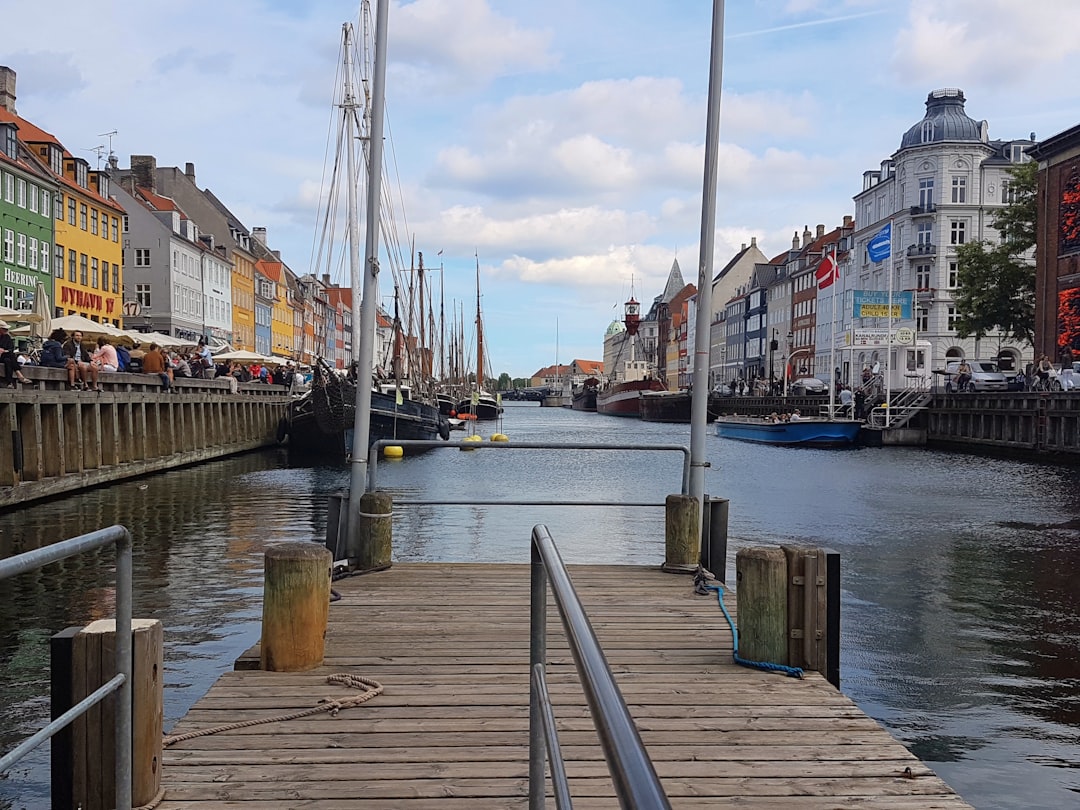 Colorful townhouses along a Christianshavn canal in Copenhagen at golden hour with bicycles in foreground
