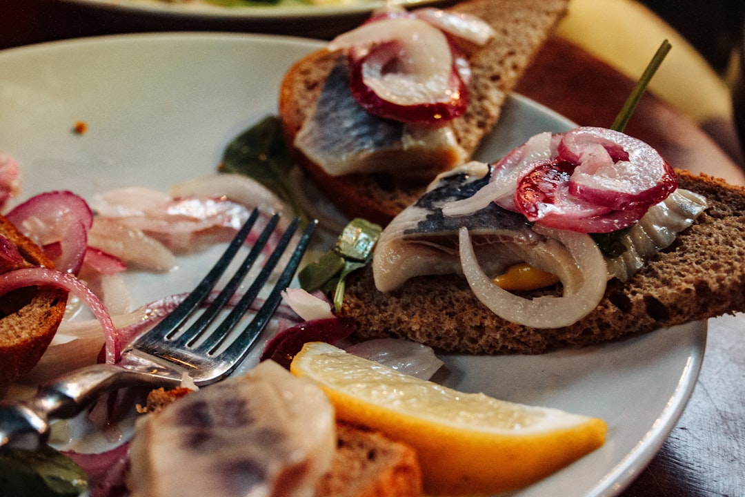 Traditional Danish smørrebrød open-faced sandwiches on dark rye bread at a Copenhagen restaurant