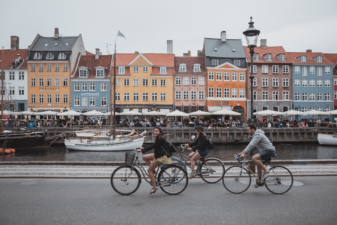 Quiet Copenhagen street with parked bicycles and outdoor café seating in Vesterbro neighborhood