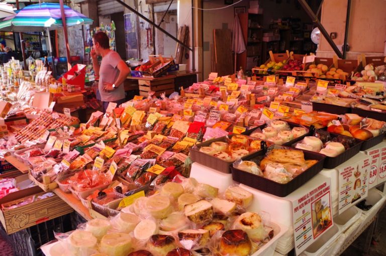Ballarò street market in Palermo Sicily with fruit vendors and Chiesa del Carmine dome
