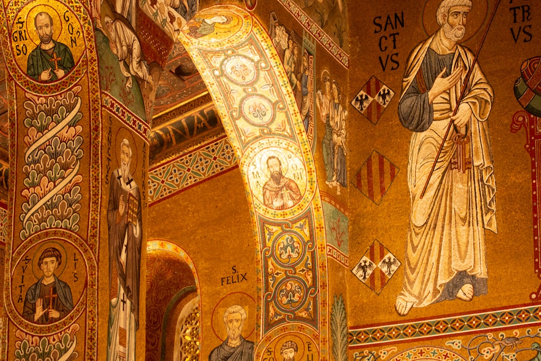 Gold Byzantine mosaics and Islamic muqarnas ceiling inside Cappella Palatina Palermo
