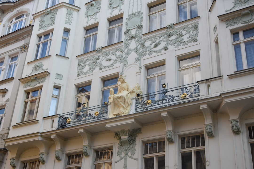 Art Nouveau carved floral ornamentation and wrought-iron balcony on a Prague residential building