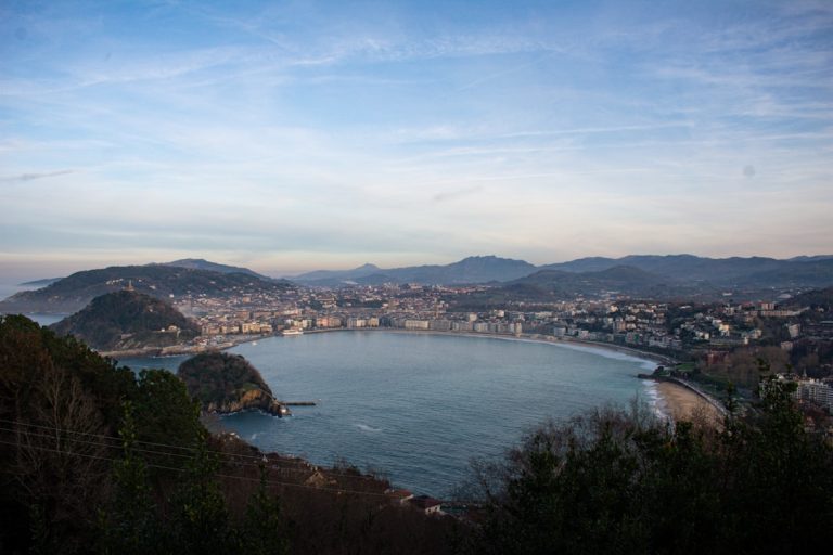 La Concha Bay in San Sebastián at golden hour with Belle Époque railings and Monte Urgull