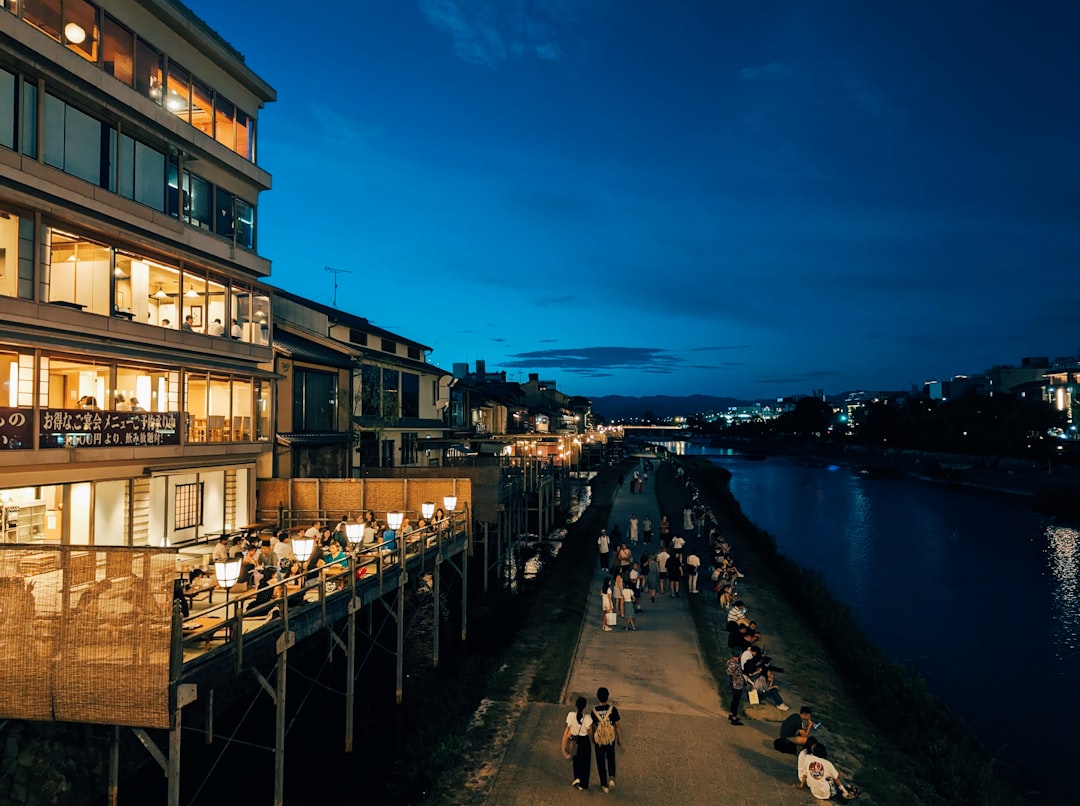 Restaurant patios lit at dusk along the Christina River waterfront in Wilmington Delaware