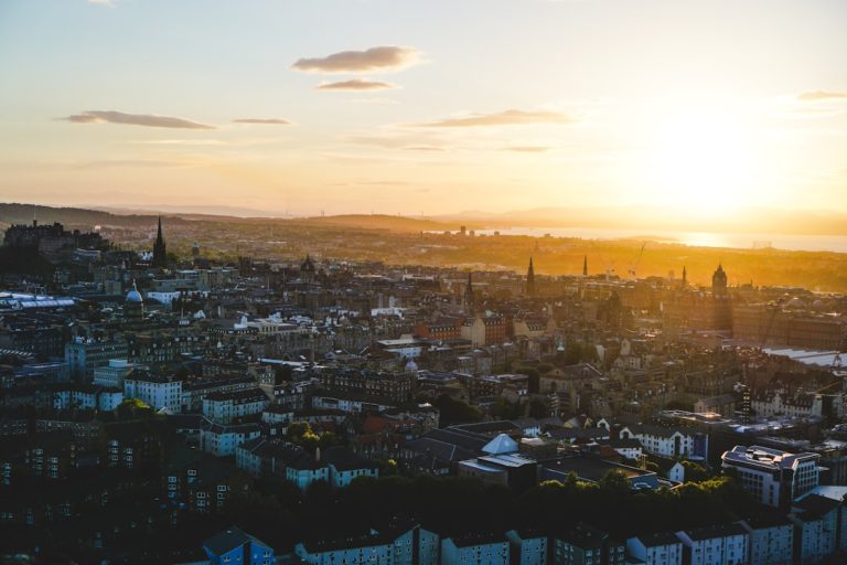 Edinburgh skyline from Calton Hill at golden hour with Edinburgh Castle and New Town rooftops