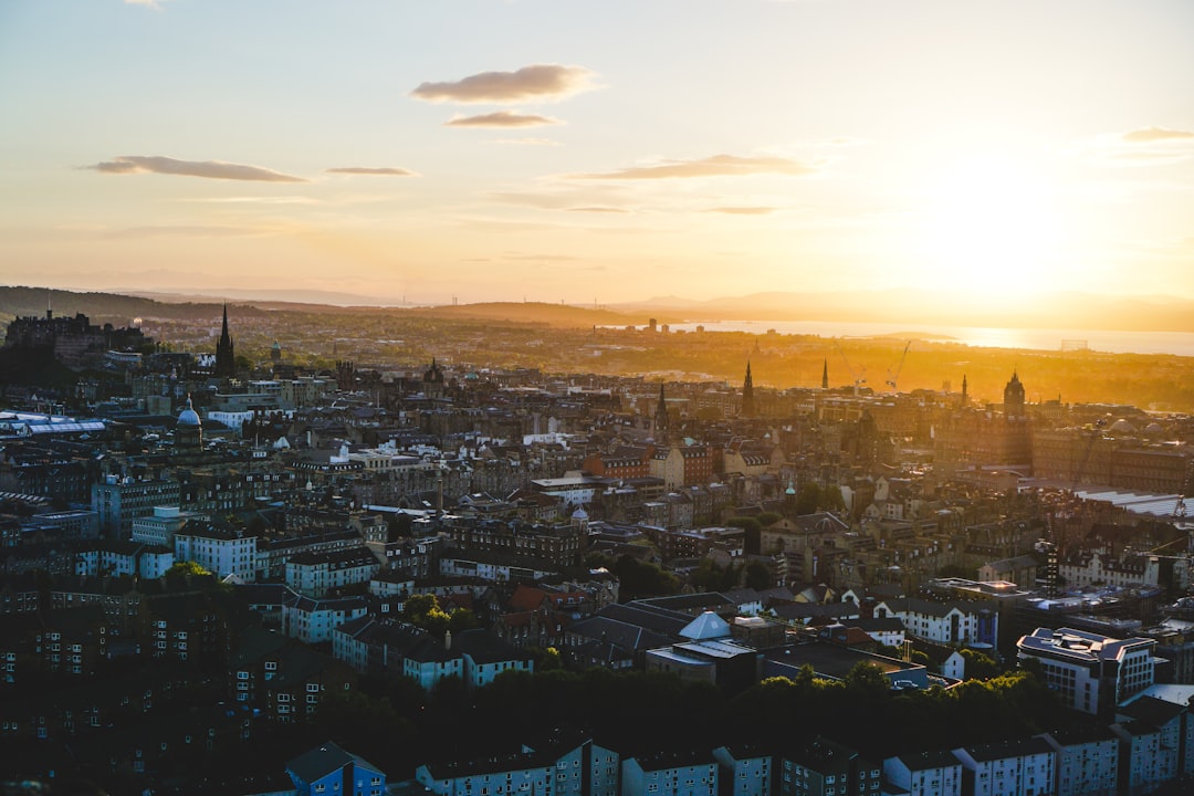 Edinburgh skyline from Calton Hill at golden hour with Edinburgh Castle and New Town rooftops
