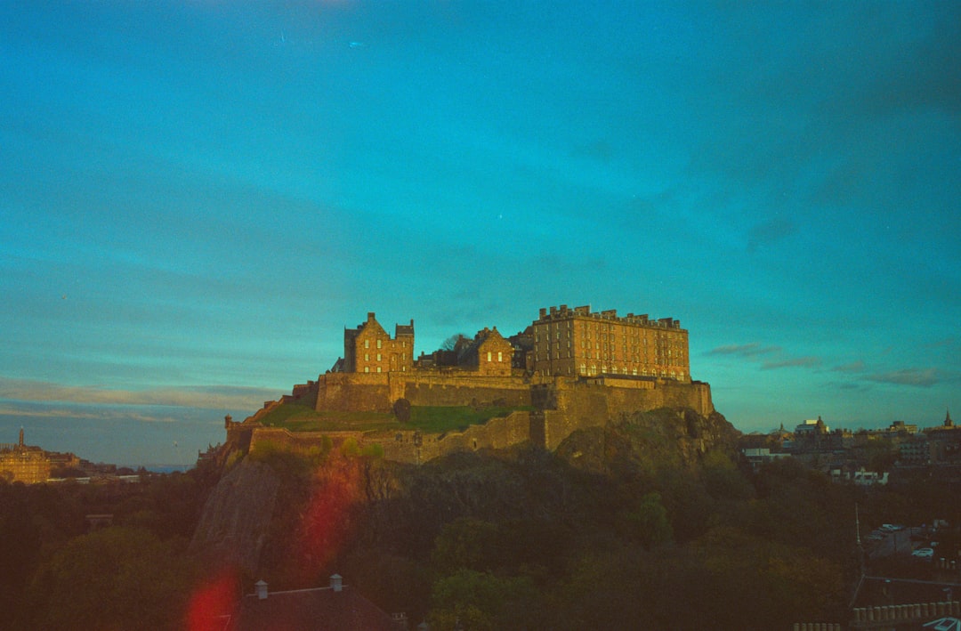 Edinburgh Castle illuminated at dusk viewed from the Grassmarket