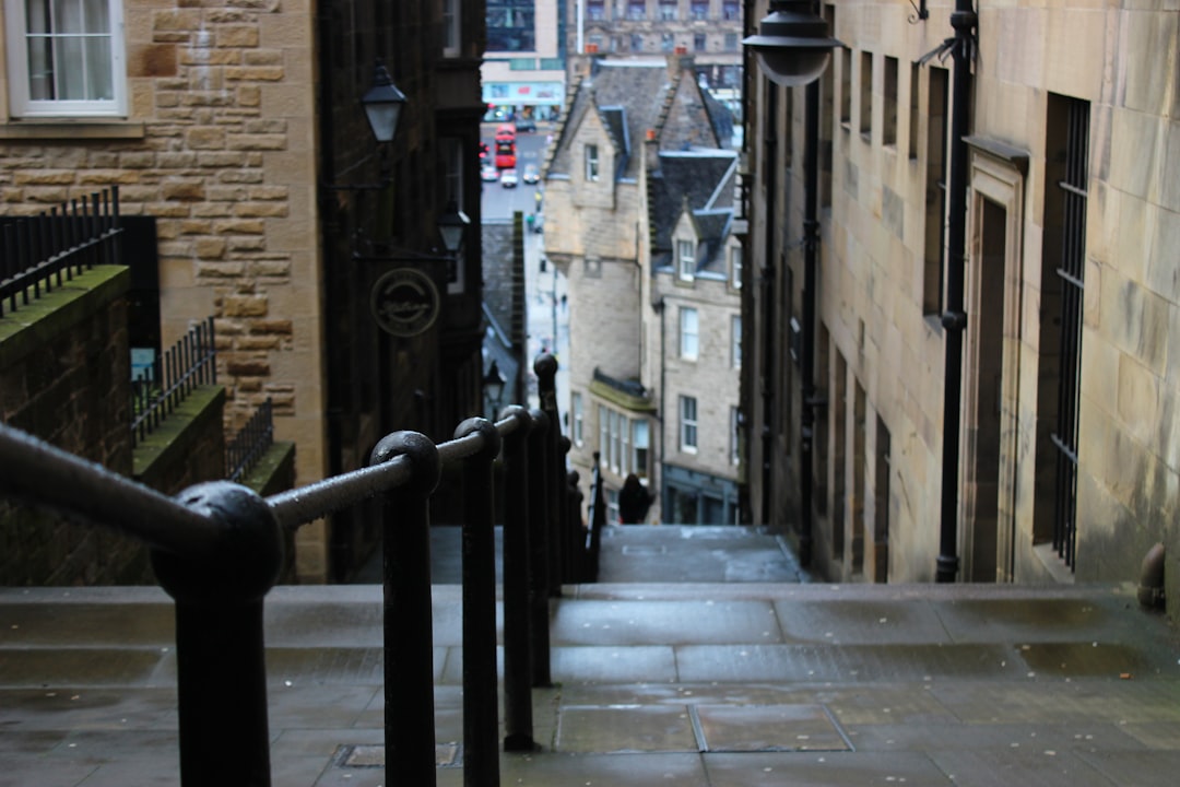 Narrow stone close in Edinburgh's Old Town with steep stairs and high walls