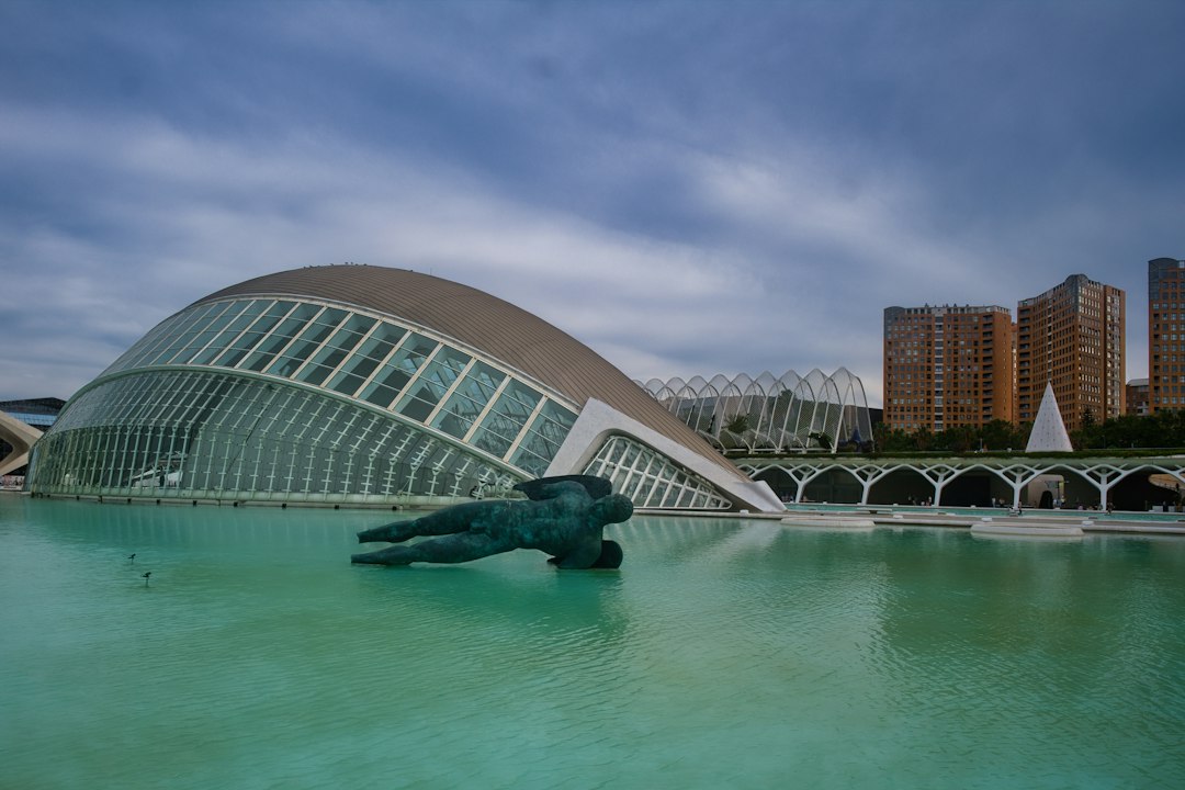 Hemisfèric building at dusk reflected in pool at City of Arts and Sciences Valencia