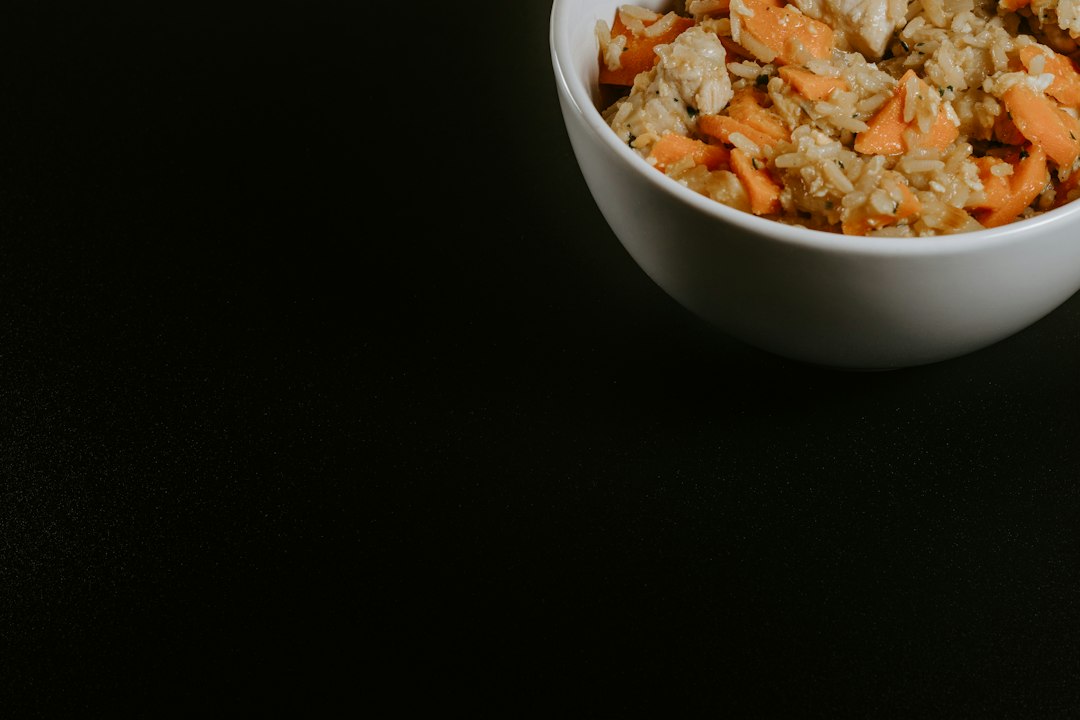 A white ceramic bowl of brown braised food