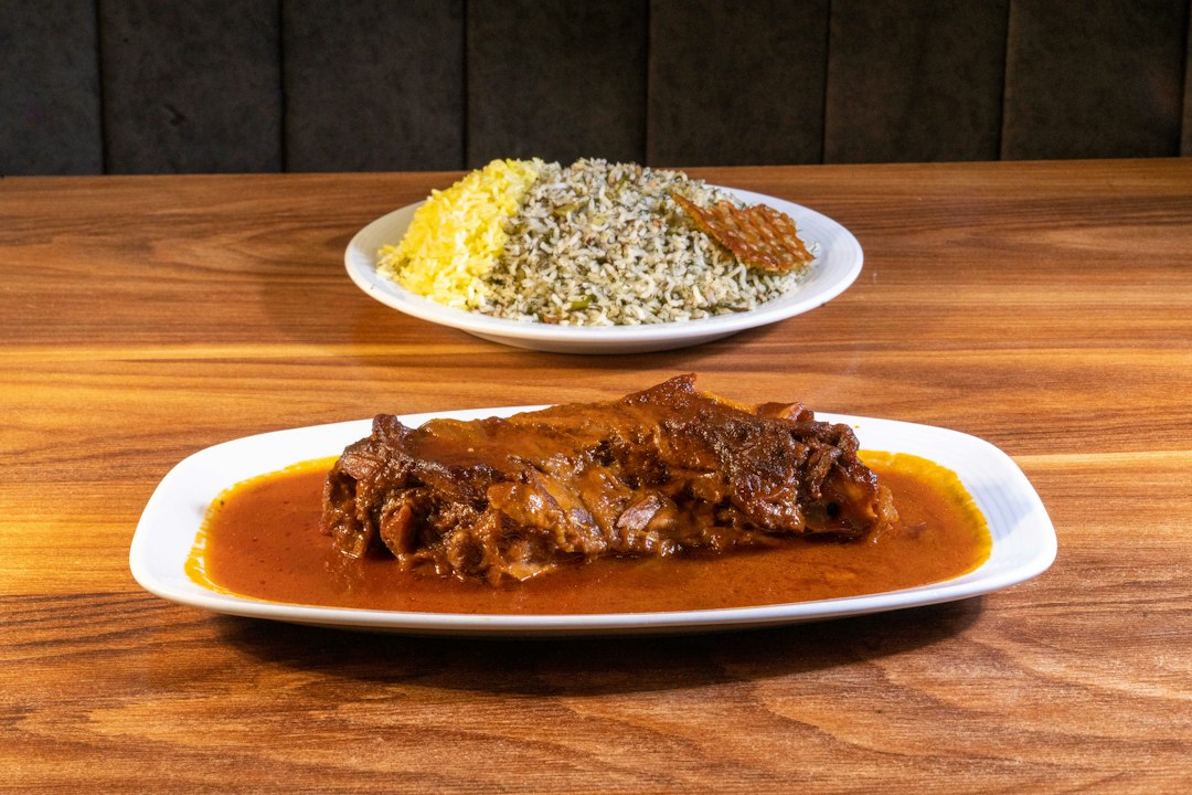 Two plates of food on a wooden table