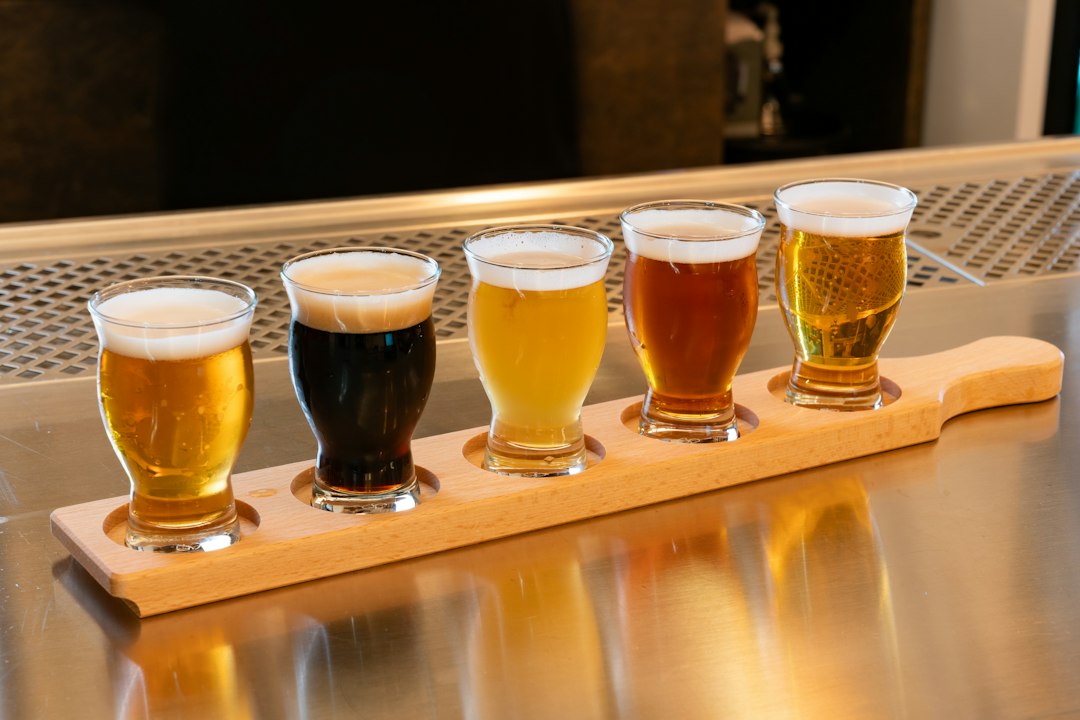 A flight of craft beers on a wooden tray