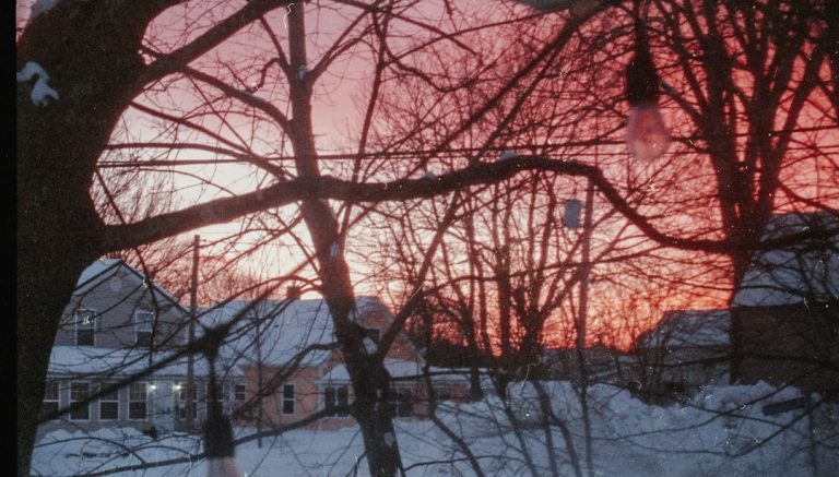The sun is setting over a snowy neighborhood in Fredericton, New Brunswick