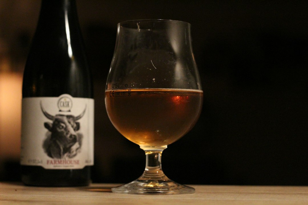 Glass of dark Belgian ale on a wooden bar