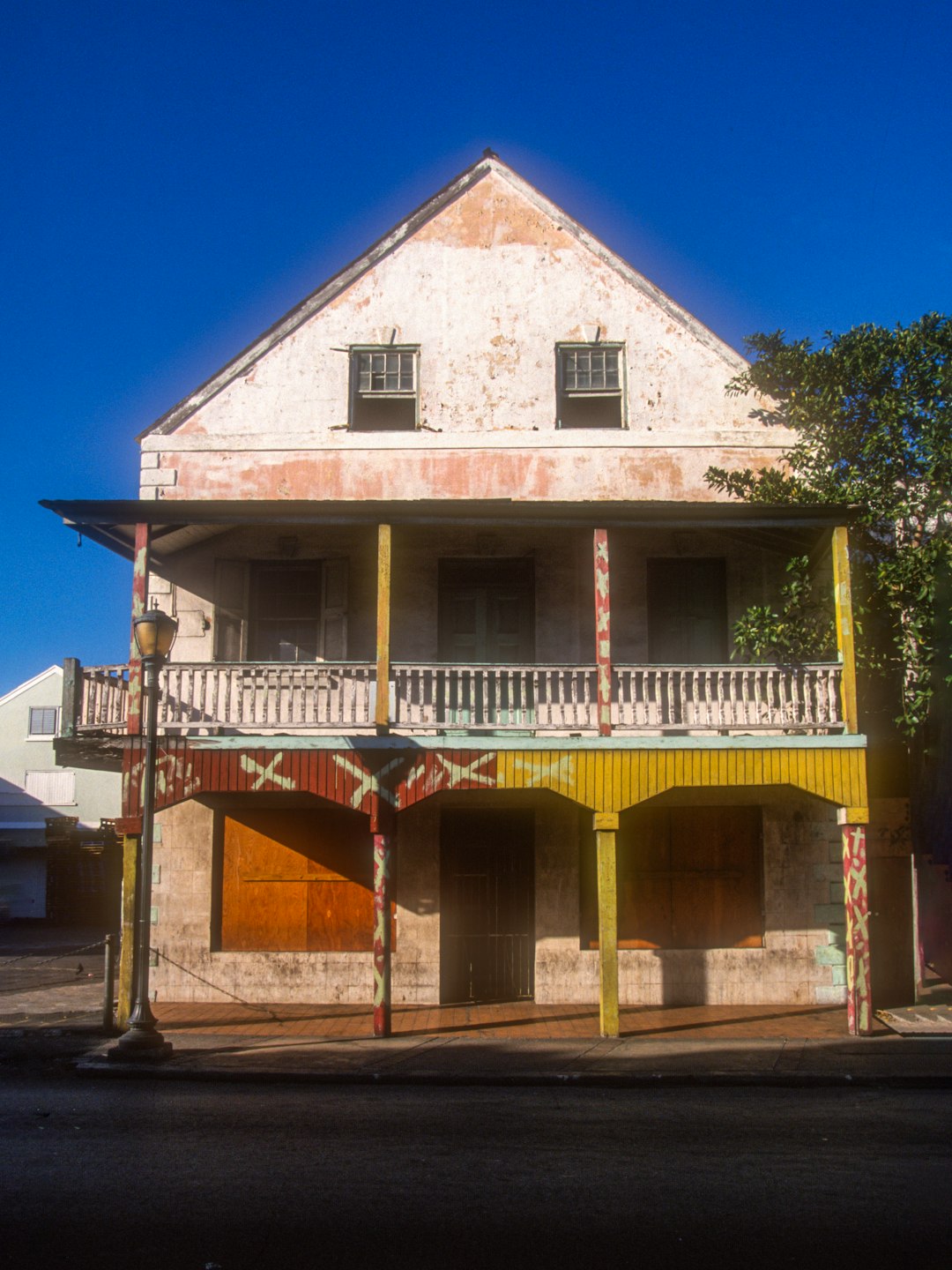 Weathered colonial-style building with a wooden balcony in Nassau, The Bahamas