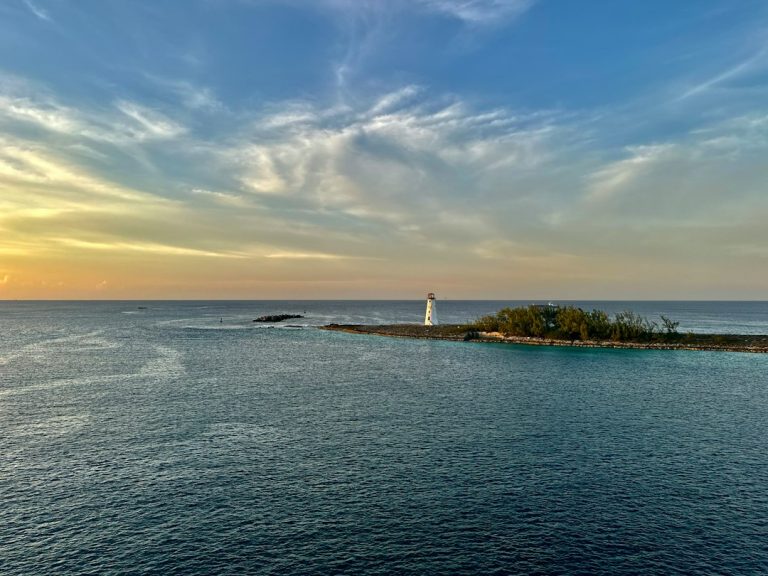 Small island with a lighthouse in Nassau harbour at sunset, The Bahamas