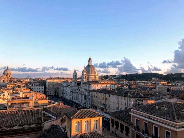 Rome, Italy: brown and white concrete building under blue sky during daytime