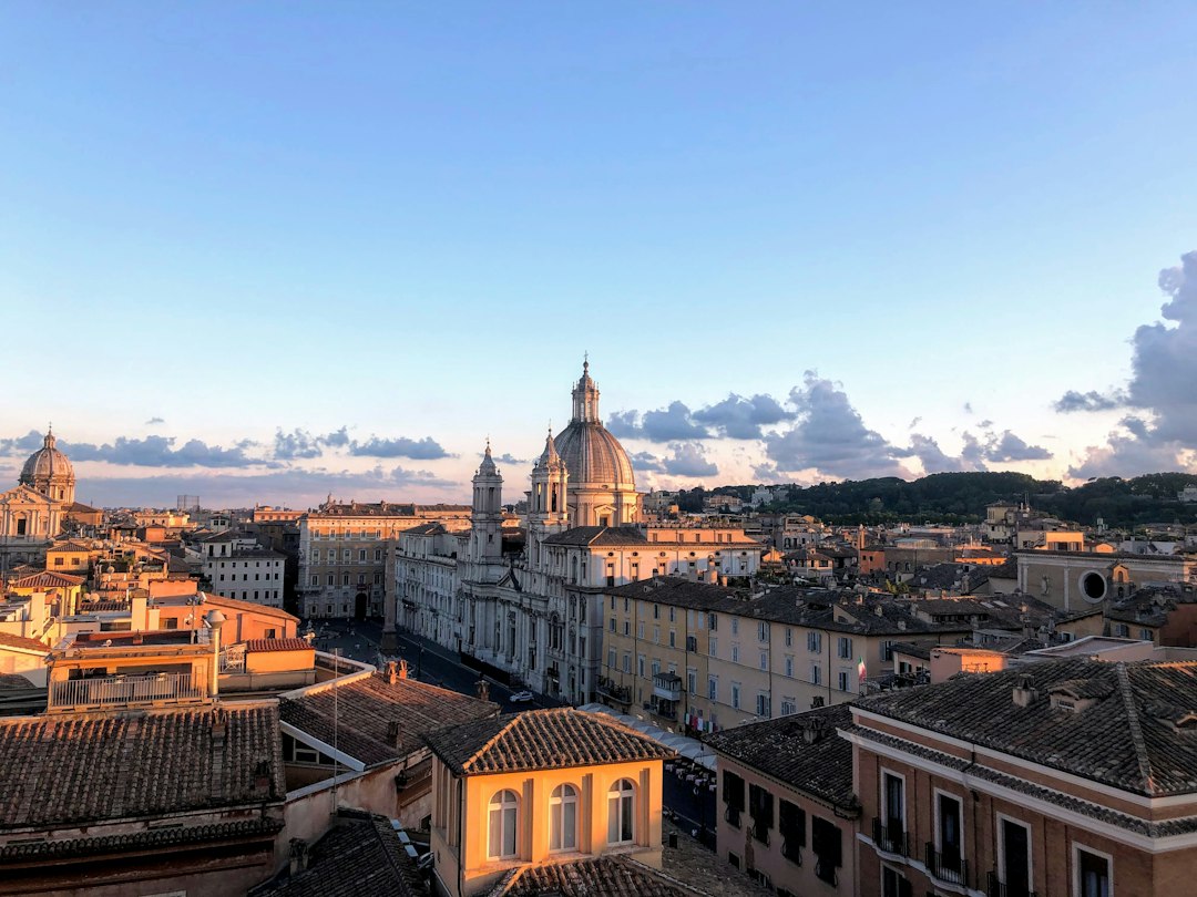 Rome, Italy: brown and white concrete building under blue sky during daytime