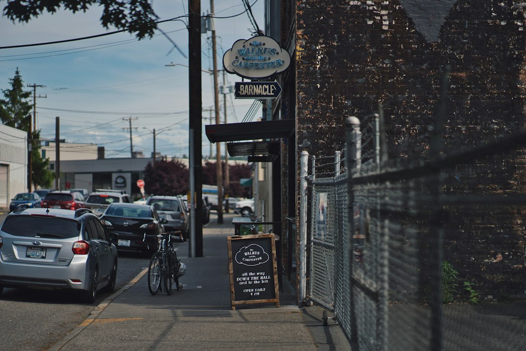 Different vehicles on road and black bike parking beside pathway in Seattle