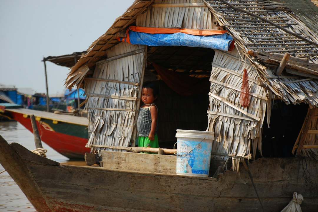 A woman standing on a boat on the Tonle Sap