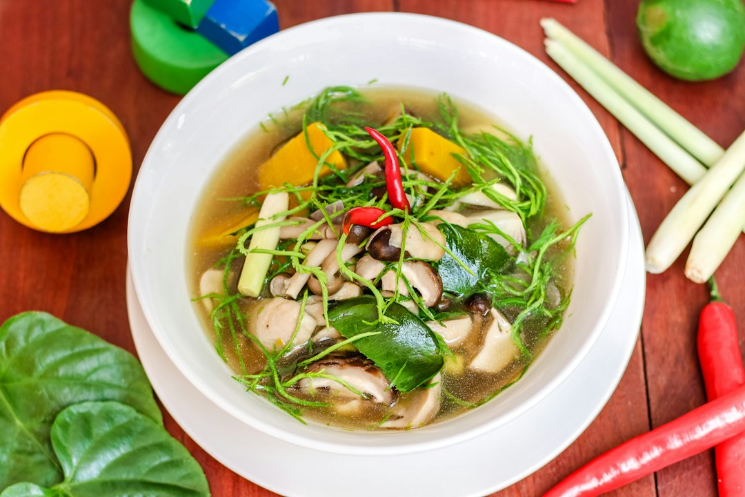 Soup with vegetables in a white ceramic bowl