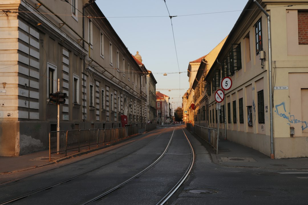 Tram tracks running between historic buildings on a street in Timișoara, Romania