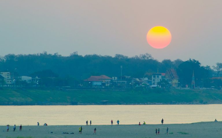 People on beach during sunset in Vientiane, Laos